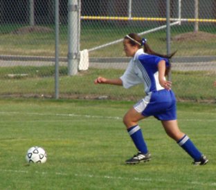 Joanna running after the soccer ball