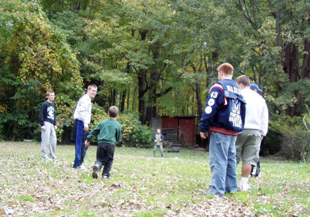 varsity football players playing with our little boys